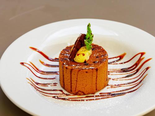 a piece of chocolate dessert on a white plate at The Rock Inn in Chipstable