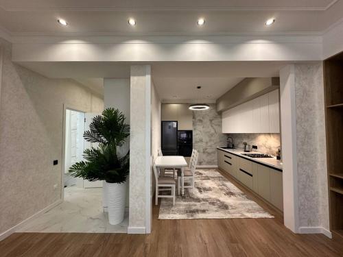 a kitchen with a plant in the middle of it at Coco Chanel Apartment in Bishkek in Bishkek