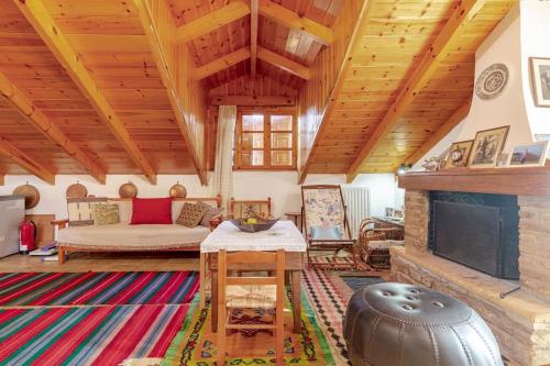 a living room with a couch and a fireplace at Stone Mountainhouse near Kalavryta, North Peloponnese, Greece in Dhoumená