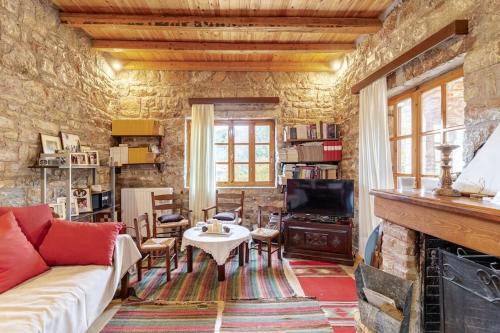 a living room with a couch and a fireplace at Stone Mountainhouse near Kalavryta, North Peloponnese, Greece in Dhoumená