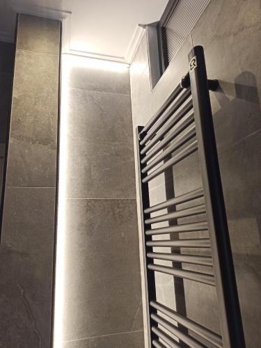 a bathroom with a shower with a glass door at Sodi Cozy apartment in Kardítsa