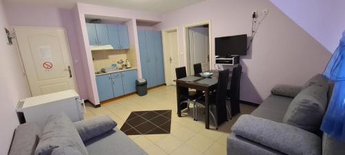 a living room with a couch and a table and a kitchen at Vila Marina Divčibare in Divčibare
