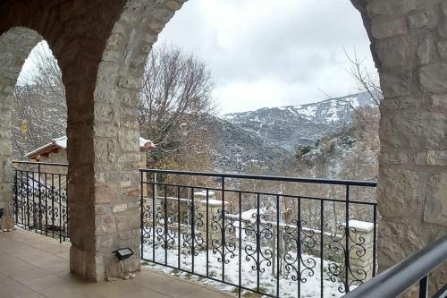a balcony with a view of a snowy mountain at Stone Mountainhouse near Kalavryta, North Peloponnese, Greece in Dhoumená