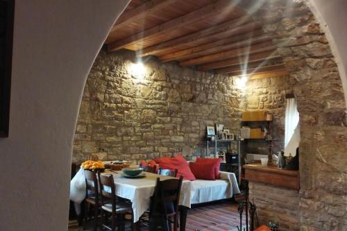 a living room with a couch and a table at Stone Mountainhouse near Kalavryta, North Peloponnese, Greece in Dhoumená