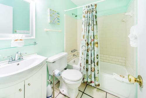 a bathroom with a sink and a toilet and a shower at Island Sands 206 in Fort Walton Beach