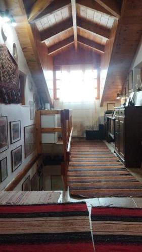 a room with a wooden floor and a large window at Stone Mountainhouse near Kalavryta, North Peloponnese, Greece in Dhoumená