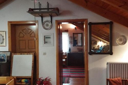 a room with a door and a mirror at Stone Mountainhouse near Kalavryta, North Peloponnese, Greece in Dhoumená