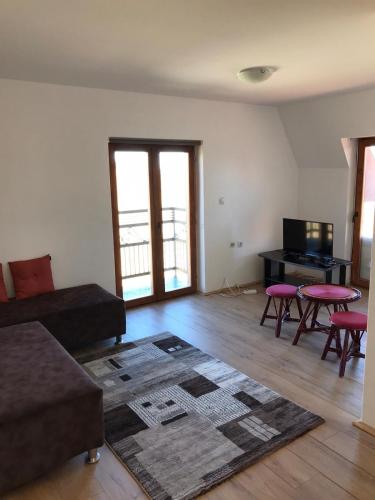 a living room with a couch and a table and chairs at Golija Vikend kuća Milenković in Raška