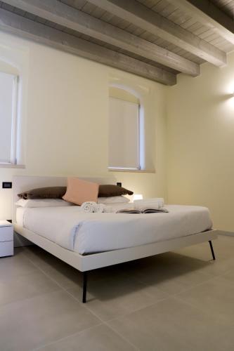 a white bedroom with a large bed in a room at Stelle di Verona - Andromeda in Verona