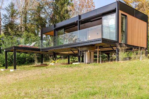 a black house on top of a field at La Suite lodge Domaine La Paloma in Jurançon