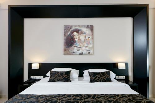 a bedroom with a large bed with a black headboard at Aar Hotel & Spa Ioannina in Ioannina