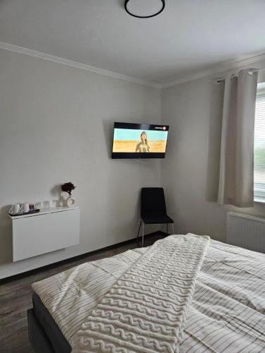 En eller flere senge i et værelse på Medelby Inn