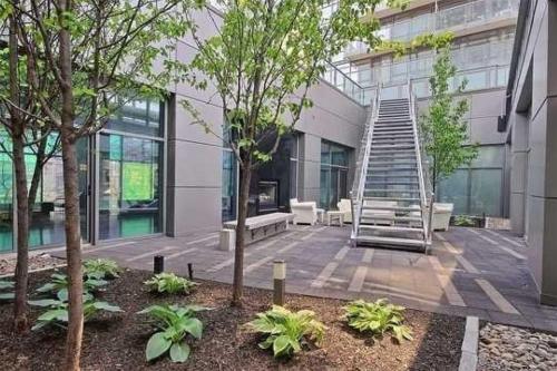 a building with a staircase in the middle of a courtyard at 44th Floor, Panoramic Views, Bay Corridor Downtown Toronto Condo in Toronto