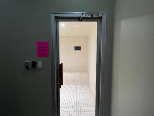 an open door to a bathroom with a walk in shower at 44th Floor, Panoramic Views, Bay Corridor Downtown Toronto Condo in Toronto