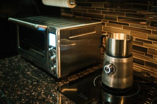 a microwave sitting on a counter next to a coffee maker at 44th Floor, Panoramic Views, Bay Corridor Downtown Toronto Condo in Toronto