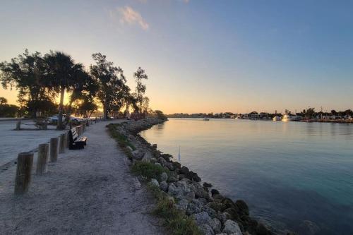 a river with a row of benches next to the water at Sunny house 2mil beach in Nokomis