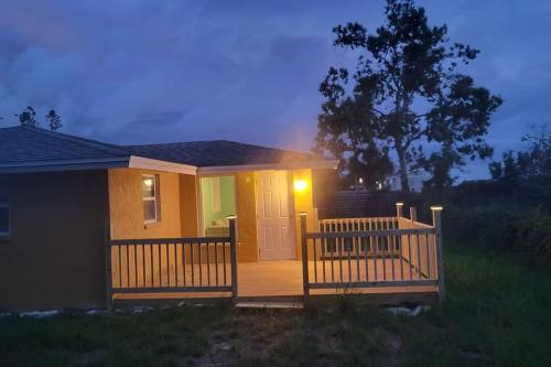 a small house with a porch with a light on it at Sunny house 2mil beach in Nokomis