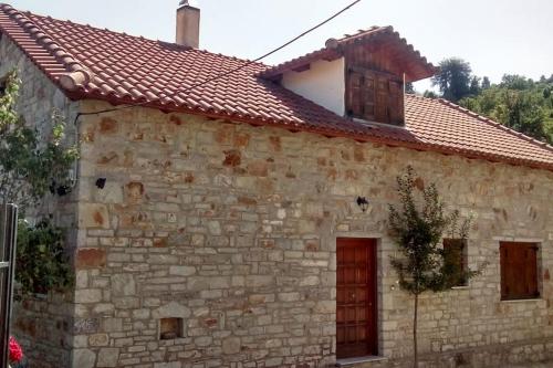 an old stone house with a red roof at Stone Mountainhouse near Kalavryta, North Peloponnese, Greece in Dhoumená