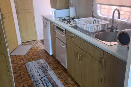 a kitchen with a sink and a stove at Cozy Cardiff Cabin Retreat sleeps 6 by Aimee in Cardiff