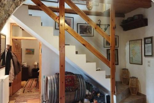 a staircase in a house with wooden beams at Stone Mountainhouse near Kalavryta, North Peloponnese, Greece in Dhoumená