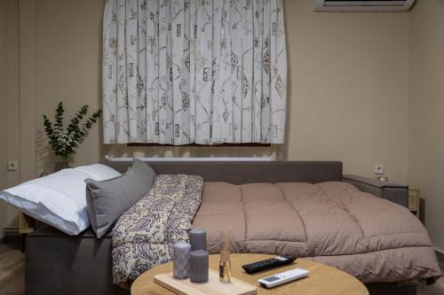 a living room with a bed and a table at Astria Apartment 1 in Kalabaka