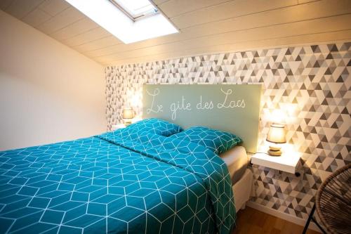 a bedroom with a blue bed with a sign that says give us dad at Gîte des lacs in Meussia