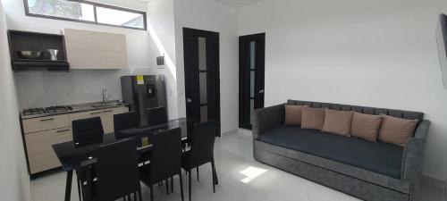 a kitchen with a couch and chairs in a room at Villa luna in Carmen de Apicalá
