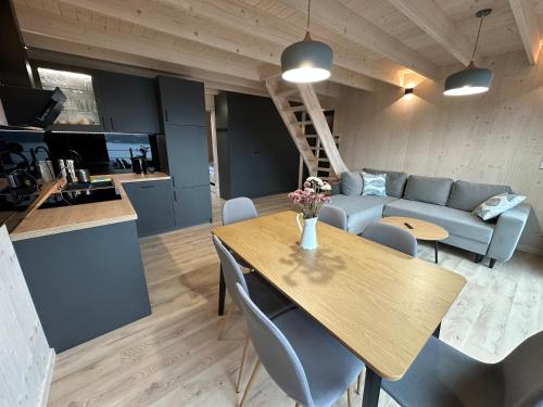 a living room with a table and a couch at Mucharskie Zacisze in Zagórze