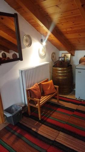 a room with a chair and a barrel in a room at Stone Mountainhouse near Kalavryta, North Peloponnese, Greece in Dhoumená