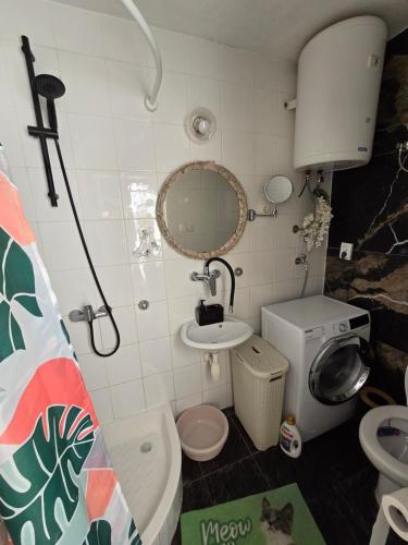 a small bathroom with a sink and a toilet at Holiday home Gariful in Milna