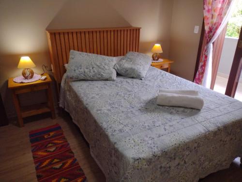 a bedroom with a large bed with two night stands at Sobrado aconchegante em Nova Petrópolis-RS perto de Gramado in Nova Petrópolis