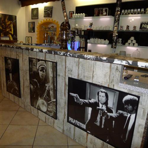 a bar with pictures of the band on it at Hotel Karthäuser Hof in Flörsheim