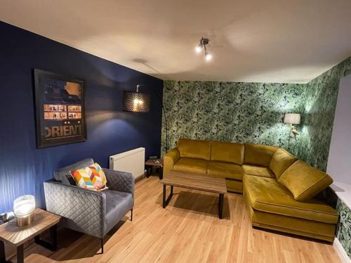 a living room with a couch and a chair at Central 2-Bed Flat, main door, on-street parking in Angus