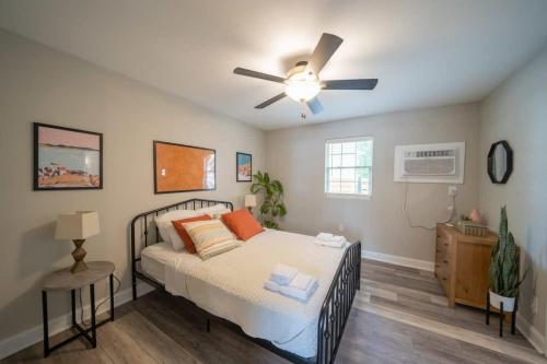 a bedroom with a bed and a ceiling fan at OV Mosaic - Float Suite in North Camellia Acres