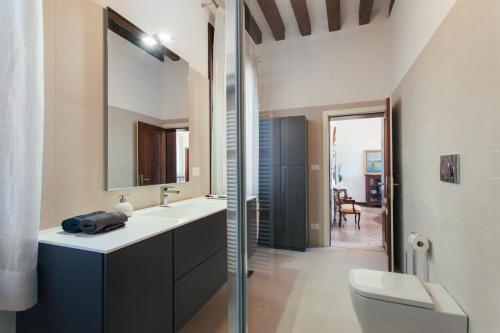 a bathroom with a sink and a toilet and a mirror at Residenza Dei Dogi in Venice