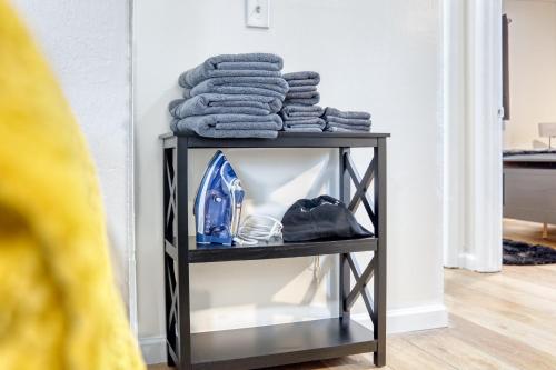 a pile of towels on a shelf in a room at Southern Charm 3-0 in Columbus
