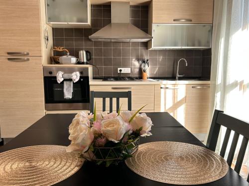 a kitchen with a table with a vase of flowers on it at Bilocale moderno a Conselve in Conselve