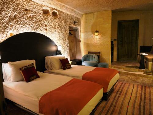 a hotel room with two beds and a bathroom at Very Peri Cappadocia - The Lifestyle Luxury Design Hotel in Uchisar