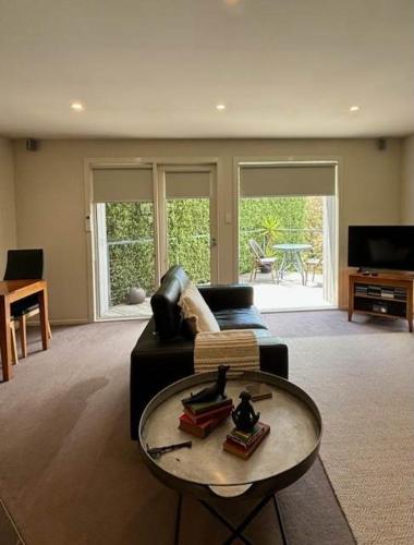 a living room with a couch and a table at Daylesford Spa Villa One in Daylesford