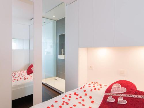 a bedroom with a bed with a red blanket and a mirror at Studio in Ostend near Beach and Promenade in Ostend