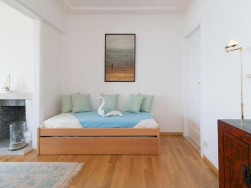 a bedroom with a bed with two swans on it at Studio in Ostend with Stunning Sea Views in Ostend