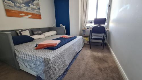 a bedroom with a bed with a chair and a desk at Spacious 3 bedroom, 2 washroom and 2 parking 5 min from train station in Blacktown