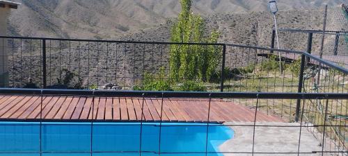 a view of a swimming pool with a fence at La Nave 2 in Potrerillos