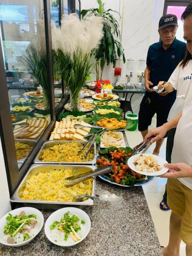 un buffet con molti piatti su un tavolo di TAM COC SUNSHINE HOTEL a Ninh Binh