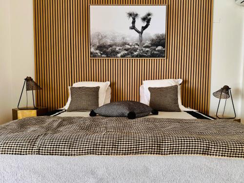 a bedroom with a bed with a striped wall at Atypik Villa in Cul de Sac