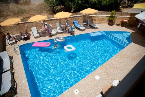 an overhead view of a swimming pool with people in it at Nikolas Suites in Kato Daratso