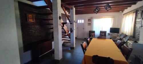 a dining room with a table and a living room at Casa verde Alfar in Mar del Plata