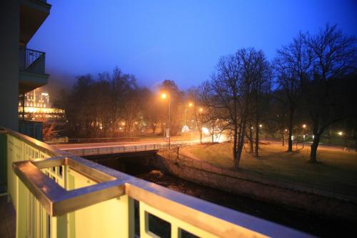a bridge over a canal in a city at night at Slunecni Lazne Apartments in Karlovy Vary