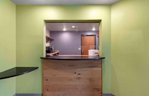 a kitchen with a large wooden island in a room at Extended Stay America Select Suites - Birmingham - Pelham in Pelham