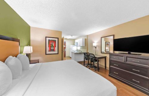 a hotel room with a bed and a flat screen tv at Extended Stay America Suites - Los Angeles - Chino Valley in Chino